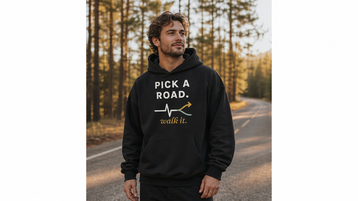 Pick a Road. Walk It. hoodie worn on a pine-lined road (model image digitally rendered)